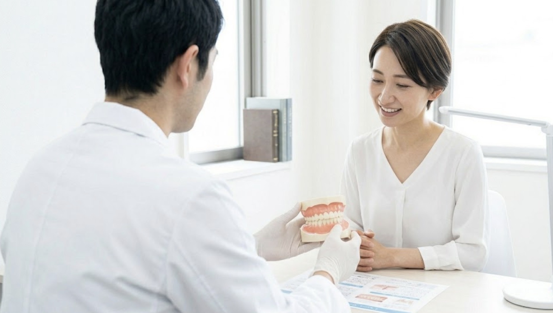 健康な親知らずの模型を使って説明を受ける女性の様子